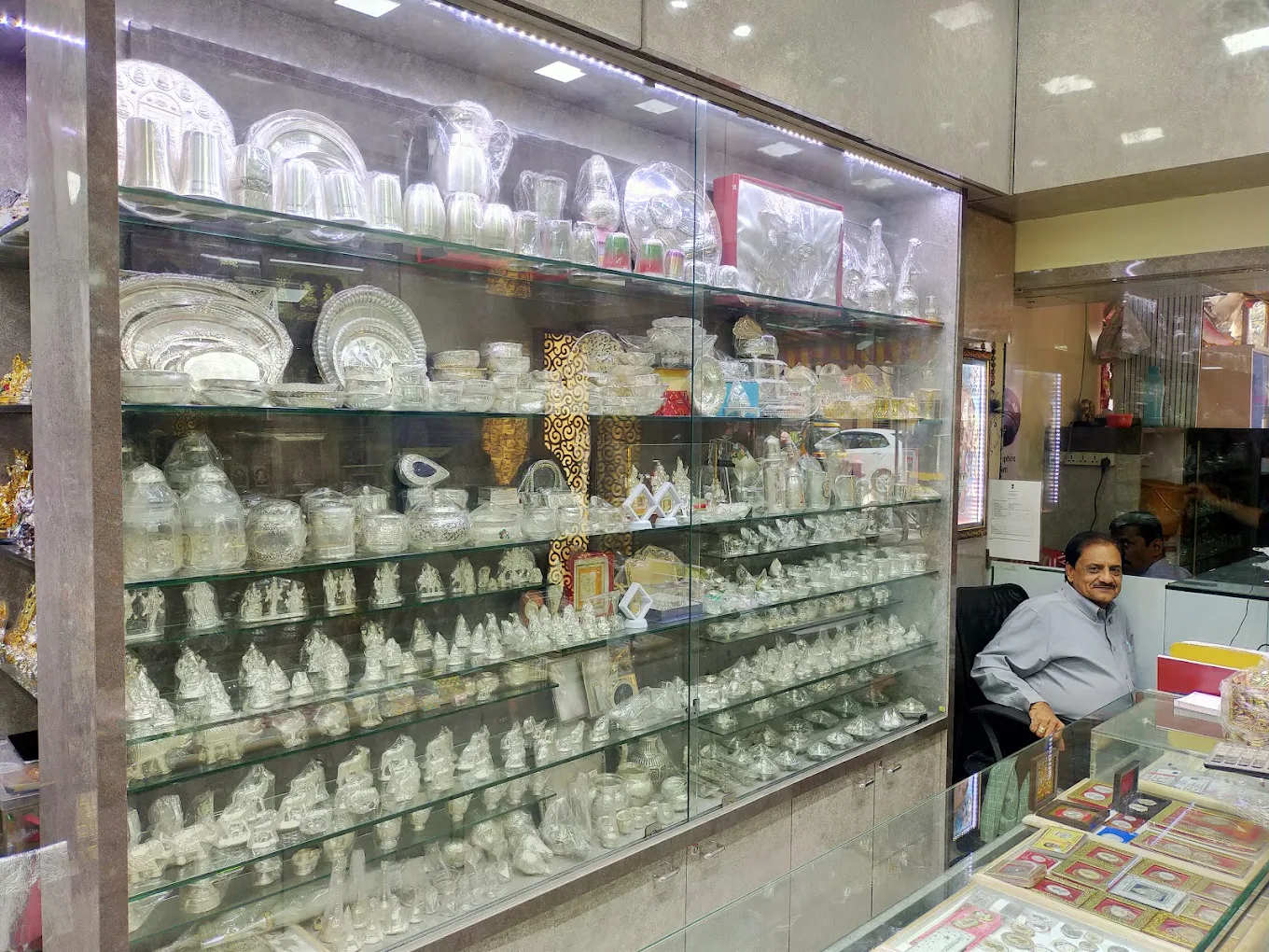 An image of one of our showrooms with floral light fixtures and clear display cases is pictured